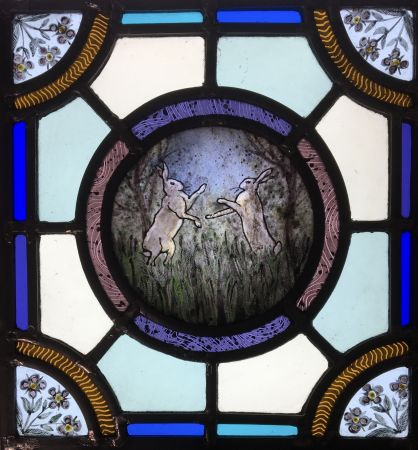 Stained glass panel with hares.