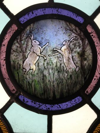 Stained glass panel with hares.