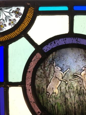 Stained glass panel with hares.