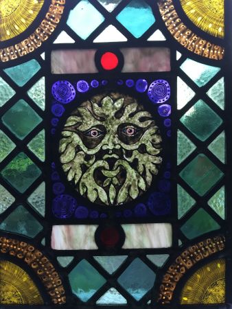 Victorian style green man stained glass panel.