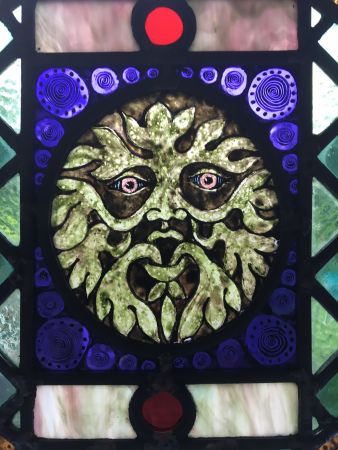 Victorian style green man stained glass panel.