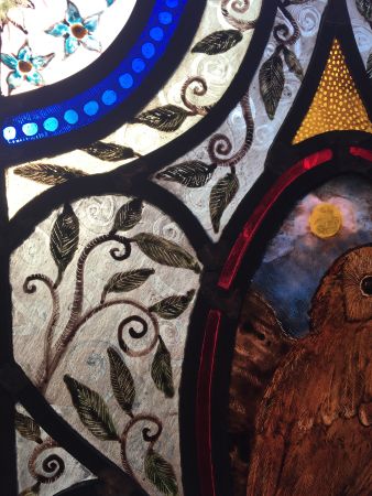 Stained glass panel with owl.