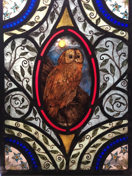 Stained glass panel with owl.